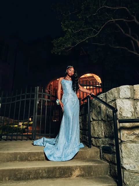 The same powder blue gown photographed on stone steps at night