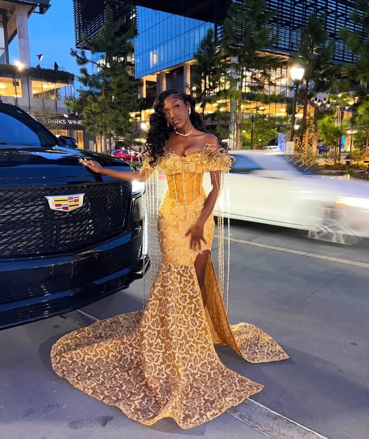 Golden off-shoulder lace gown with a sweeping train